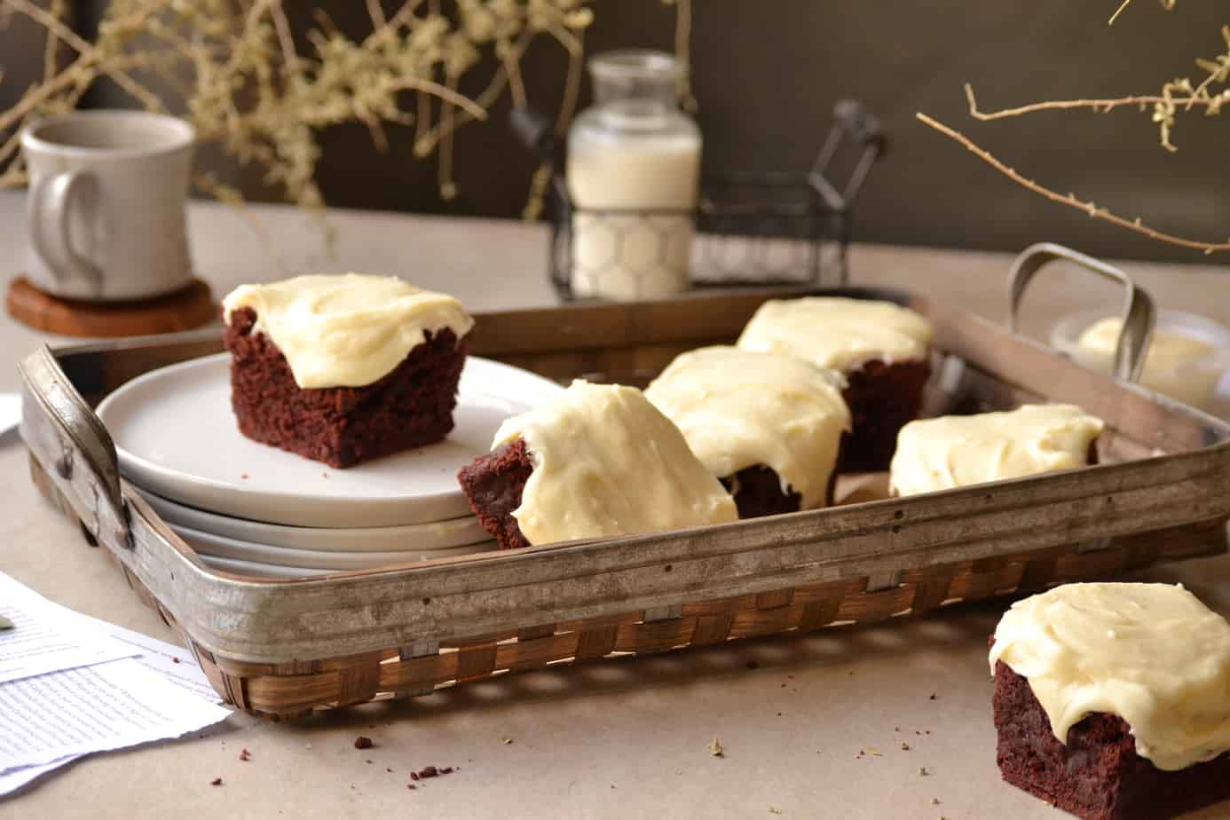 Basket of red velvet brownies with cream cheese frosting